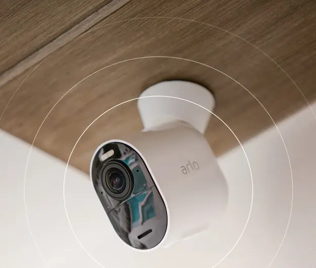 Image of an Arlo security camera with emanating circles representing sound waves